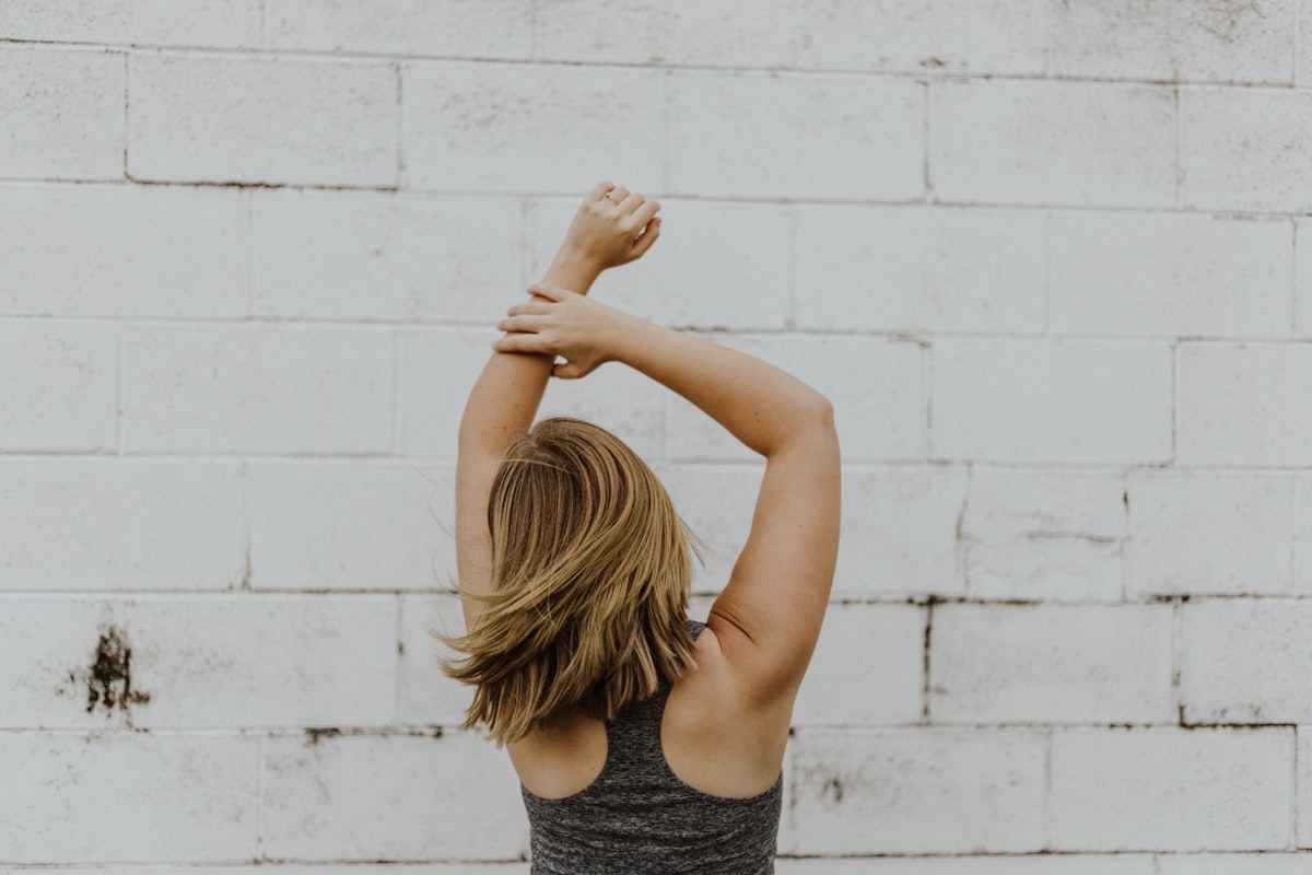 Mature woman performing dynamic stretching routine